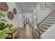 Inviting foyer with hardwood floors, modern staircase and decor leading to a chandelier-lit entryway at 4525 W Swann Ave, Tampa, FL 33609