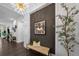 Stylish foyer featuring dark wood floors, a designer bench, and a framed art piece on the wall at 4525 W Swann Ave, Tampa, FL 33609