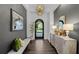 Elegant foyer with dark wood floors, custom lighting, designer decor and view to front door at 4525 W Swann Ave, Tampa, FL 33609