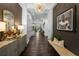 Long foyer featuring a decorative mirror, patterned sideboard, and unique pendant lighting at 4525 W Swann Ave, Tampa, FL 33609