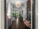 Bright foyer with dark wood floors, chandelier, detailed trim, and views to the main level staircase at 4525 W Swann Ave, Tampa, FL 33609