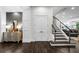 Open foyer with views of the staircase, a mirrored sideboard, and wood flooring at 4525 W Swann Ave, Tampa, FL 33609