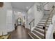 Elegant foyer with hardwood floors, chandelier, and staircase with wooden treads and stainless steel railings at 4525 W Swann Ave, Tampa, FL 33609