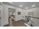 Upper hallway featuring wood floors and a view of the living room at 4525 W Swann Ave, Tampa, FL 33609