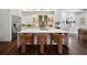 Contemporary kitchen featuring stainless steel appliances, quartz countertops, and stylish seating at the island at 4525 W Swann Ave, Tampa, FL 33609