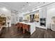 Bright kitchen with stainless steel appliances, a large island with seating, and wood floors at 4525 W Swann Ave, Tampa, FL 33609