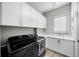 Well-organized laundry room with sleek washer/dryer and ample storage, enhancing functionality at 4525 W Swann Ave, Tampa, FL 33609