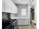 Functional laundry room features a sleek washer/dryer set, counter space, and cabinet storage at 4525 W Swann Ave, Tampa, FL 33609