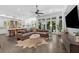 Open-concept living room showcasing a plush sofa, seamless access to the outdoors, and a modern kitchen at 4525 W Swann Ave, Tampa, FL 33609
