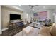 Comfortable living room featuring neutral tones, entertainment area, and colorful decorations at 4525 W Swann Ave, Tampa, FL 33609