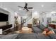 Open living space featuring a modern staircase, entertainment center, and seamless flow to other areas at 4525 W Swann Ave, Tampa, FL 33609