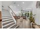 Open concept living room with a modern staircase, hardwood floors, and seamless access to the outdoors at 4525 W Swann Ave, Tampa, FL 33609