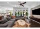 Spacious living room showcasing a large sofa, modern decor, and seamless access to a backyard pool at 4525 W Swann Ave, Tampa, FL 33609