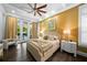 Bright main bedroom with a view of the pool, ceiling fan, and wood floors at 4525 W Swann Ave, Tampa, FL 33609