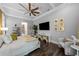 Spacious main bedroom with wood floors, a ceiling fan, television and ample seating at 4525 W Swann Ave, Tampa, FL 33609