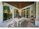 This covered patio offers seamless indoor/outdoor dining with views of the lush landscaping at 4525 W Swann Ave, Tampa, FL 33609