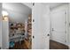 Organized pantry with shelving for ample storage, next to a hall with a white door at 4525 W Swann Ave, Tampa, FL 33609