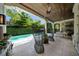 The covered patio offers seamless indoor/outdoor living with a full kitchen and views of the sparkling pool at 4525 W Swann Ave, Tampa, FL 33609