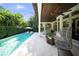 The refreshing in-ground pool is surrounded by lush landscaping and a covered patio for seamless outdoor living at 4525 W Swann Ave, Tampa, FL 33609