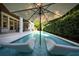 Relax on the integrated chaise lounges in this backyard oasis with lush landscaping and a refreshing in-ground pool at 4525 W Swann Ave, Tampa, FL 33609