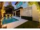 A luxurious pool featuring modern lounge chairs and lush landscaping for ultimate relaxation and outdoor enjoyment at 4525 W Swann Ave, Tampa, FL 33609