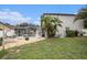 Backyard with a screened-in pool and mature tropical landscaping at 4738 Bloom Dr, Plant City, FL 33566