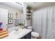 Cozy bathroom featuring a vanity, decorated shelves and patterned shower curtain at 4738 Bloom Dr, Plant City, FL 33566