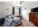 Cozy bedroom with blue accents, natural light from the window, a dresser, and a double closet for ample storage at 4738 Bloom Dr, Plant City, FL 33566