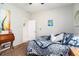 Bedroom with queen bed has a desk and a door that leads to an en suite bathroom at 4738 Bloom Dr, Plant City, FL 33566