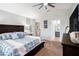 Vaulted ceiling bedroom with ceiling fan has a king bed with blue bedding and dark wood dresser at 4738 Bloom Dr, Plant City, FL 33566
