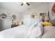 Bright bedroom featuring a ceiling fan, white bedding and round mirror at 4738 Bloom Dr, Plant City, FL 33566