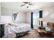 Bright bedroom featuring a ceiling fan, large window and coastal decor at 4738 Bloom Dr, Plant City, FL 33566