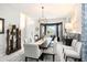 Dining room with modern light fixture, decor and adjacent windows at 4738 Bloom Dr, Plant City, FL 33566