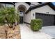 Close-up of two-story home featuring front entryway, stone landscaping, and a two-car garage at 4738 Bloom Dr, Plant City, FL 33566