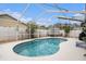 Screened-in pool and patio with mature landscaping create a private backyard retreat at 4738 Bloom Dr, Plant City, FL 33566