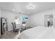 The main bedroom features a plush bed, an accent chair and a flat screen television at 4741 76Th N Ave, Pinellas Park, FL 33781