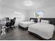 Bright bedroom with two twin beds, wood floors, and a desk area at 4741 76Th N Ave, Pinellas Park, FL 33781