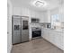 Bright kitchen features stainless steel appliances, white cabinets, and wood-look flooring at 4741 76Th N Ave, Pinellas Park, FL 33781