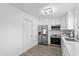 Bright kitchen features stainless steel appliances, white cabinets, and wood-look flooring at 4741 76Th N Ave, Pinellas Park, FL 33781