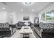 Bright living room with plush gray seating, modern decor, and ample natural light from large windows at 4741 76Th N Ave, Pinellas Park, FL 33781