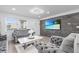 Cozy living room featuring stylish gray couches, a modern stone accent wall, and natural light at 4741 76Th N Ave, Pinellas Park, FL 33781