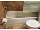 Bathroom features a white toilet, tub, and shower at 4811 Puritan Cir # 4811, Tampa, FL 33617