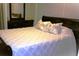 This bedroom features a white bedspread and floral pillows at 4811 Puritan Cir # 4811, Tampa, FL 33617