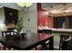 Cozy dining area with dark wood table and chairs next to an open-concept kitchen at 4811 Puritan Cir # 4811, Tampa, FL 33617