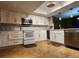 Bright kitchen featuring modern appliances, white cabinetry, and a stylish backsplash at 4811 Puritan Cir # 4811, Tampa, FL 33617