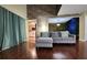 Inviting living room featuring hardwood floors, stylish furnishings, and a unique accent wall at 4811 Puritan Cir # 4811, Tampa, FL 33617