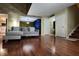 Open-concept living room with hardwood floors, a comfortable sofa, and stylish accents at 4811 Puritan Cir # 4811, Tampa, FL 33617