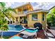 Backyard showcasing a pool, lounge chairs, and outdoor dining set, creating an ideal space for relaxation at 539 Treviso Dr, Apollo Beach, FL 33572