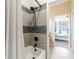 Bathroom tiled shower and tub showcasing neutral tiles with decorative accents and modern fixtures at 539 Treviso Dr, Apollo Beach, FL 33572