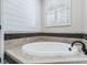 Spa-like bathroom showcasing a large white soaking tub and elegant tile work at 539 Treviso Dr, Apollo Beach, FL 33572
